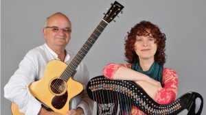 A guitarist and a harpist holding their instruments.